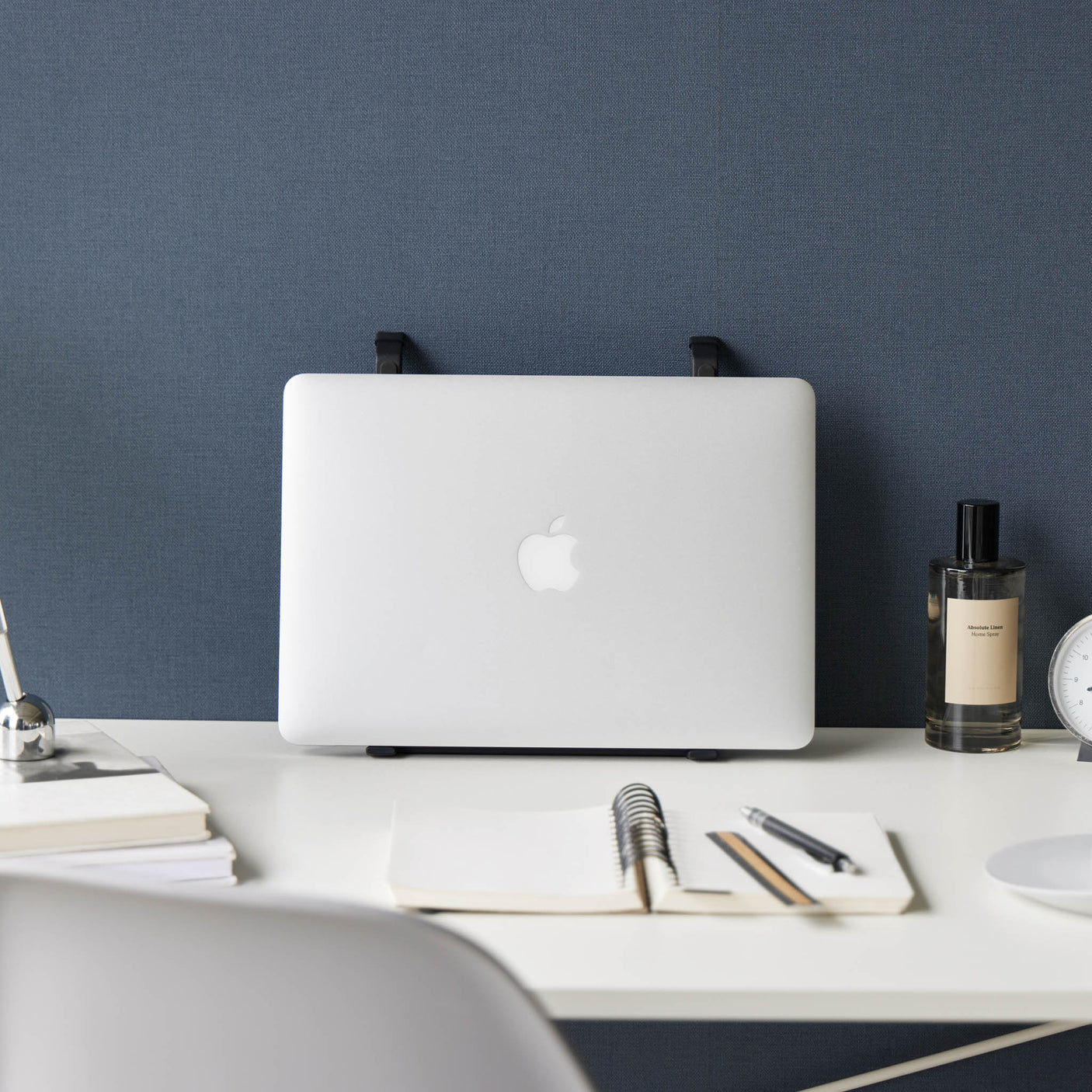 Sammenleggbart sort stativ for laptop på hjemmekontor.