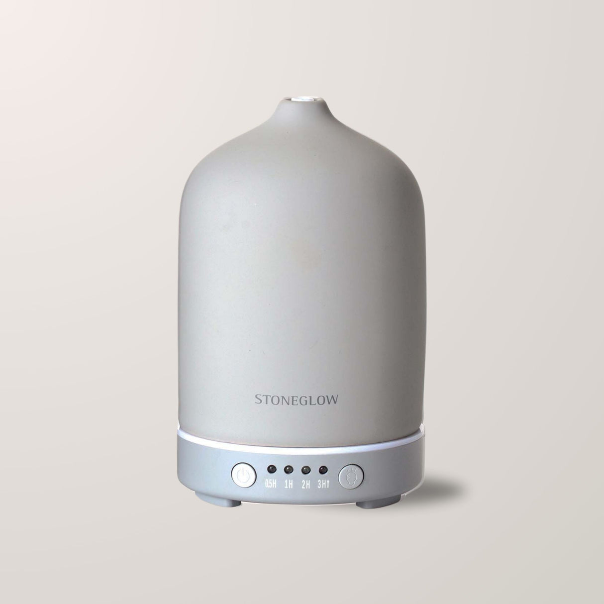 Duftdiffuser i keramisk finish, viser damp og belysning.