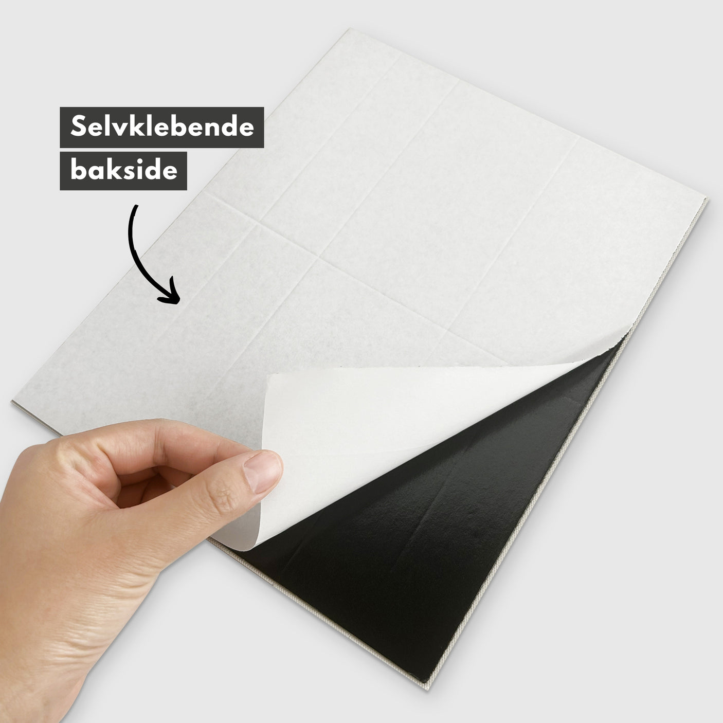 Bakside av Alma grønn marmorfliser der det selvklebende laget fjernes.