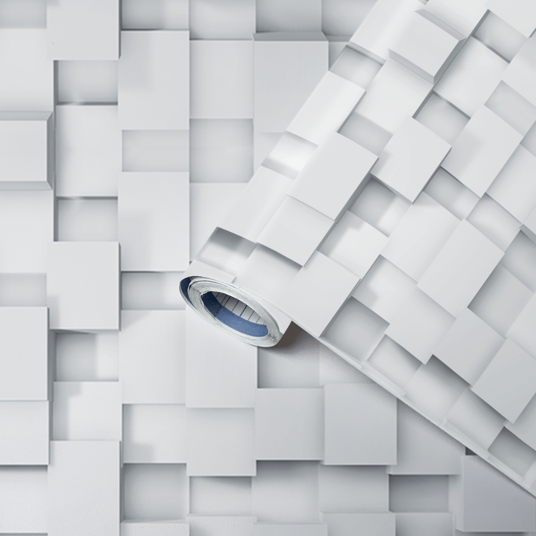 Rull med hvit kontaktplast i 3D-terningmønster, vist på et underlag med samme mønster.