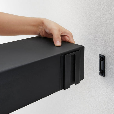 Sort vegghylle med magnetfunksjon for praktisk oppbevaring.