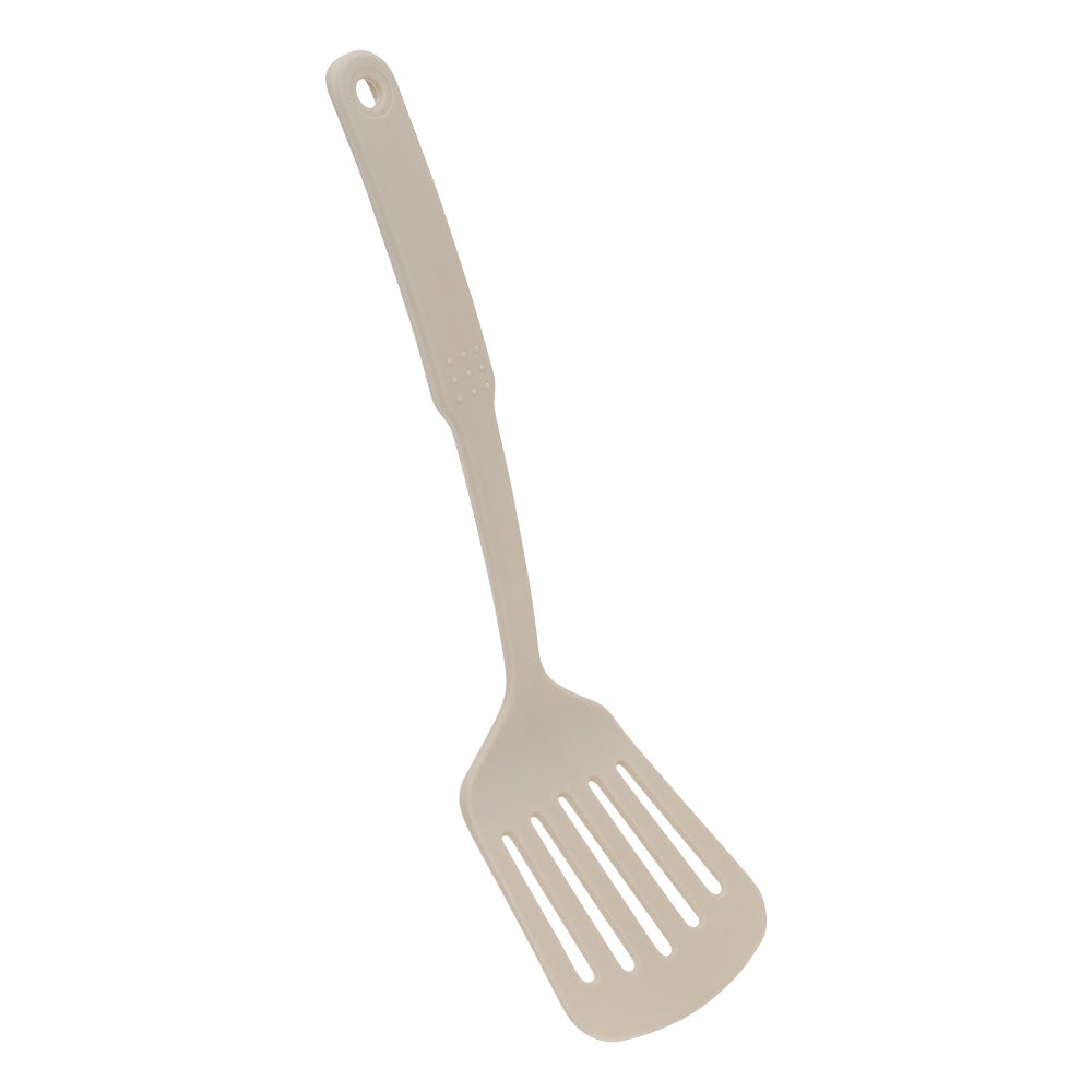 Beige stekespade med hull fra kokekarsettet