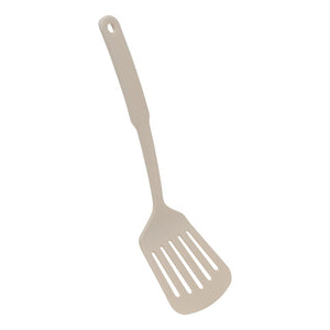 Beige stekespade med hull fra kokekarsettet