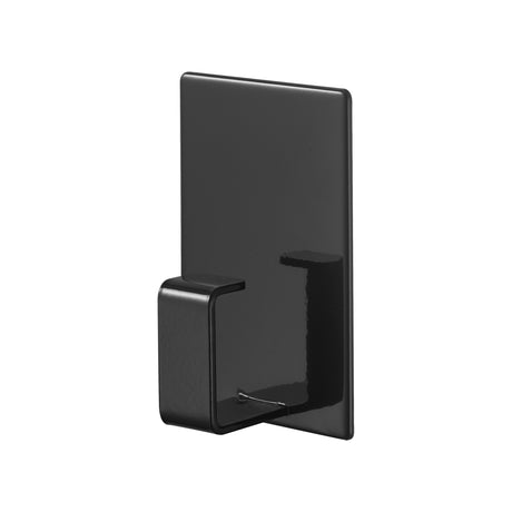 Sort magnetisk opphengskrok festet på vaskemaskin.