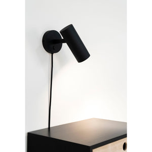 Paris vegglampe montert over nattbord i moderne soverom