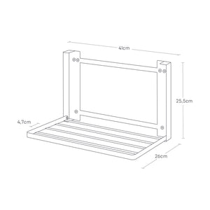 Sort oppbevaringshylle montert ved vaskemaskin.