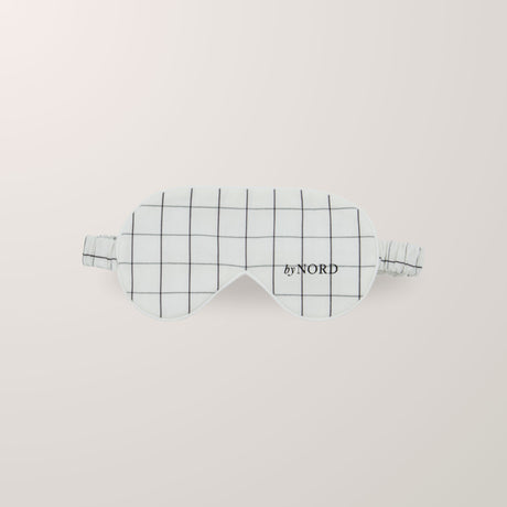 Sovemaske med ruter og elastisk stropp.