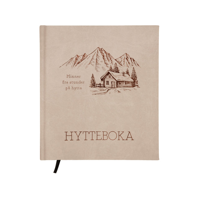 Beige hyttebok «Minner fra hytta» med fjellmotiv, 21 × 24 cm, innbundet med bokmerke.