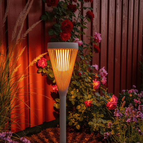 Solar flame light by red Norwegian fence